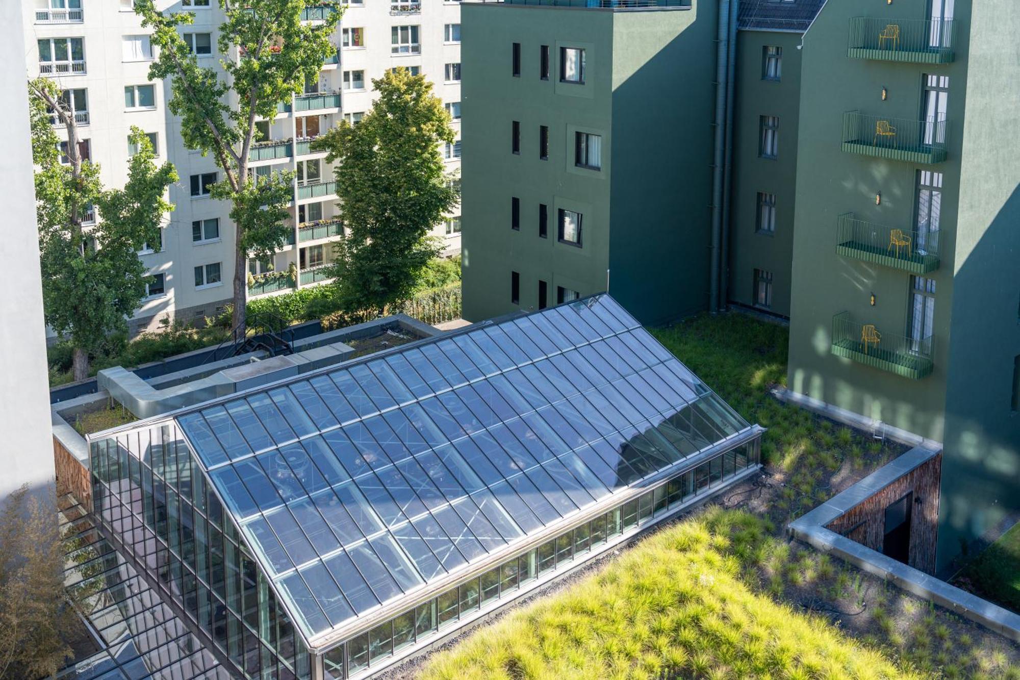 Sly Berlin Hotel Exterior photo Solar collectors on a green roof